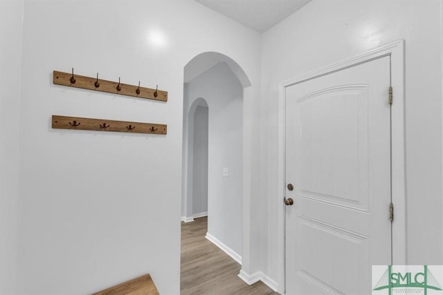 corridor with light wood-type flooring