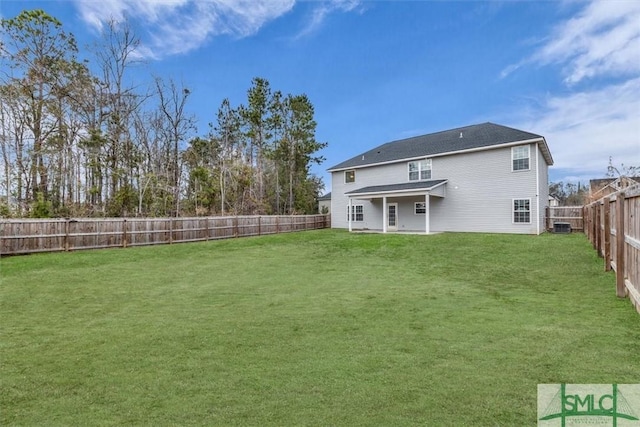 back of property featuring central AC and a yard