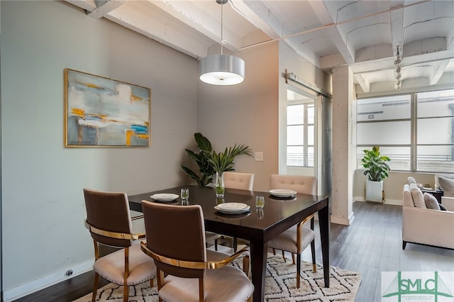 dining room with hardwood / wood-style floors and beamed ceiling