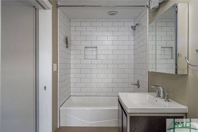 bathroom featuring vanity, tile patterned floors, and tiled shower / bath