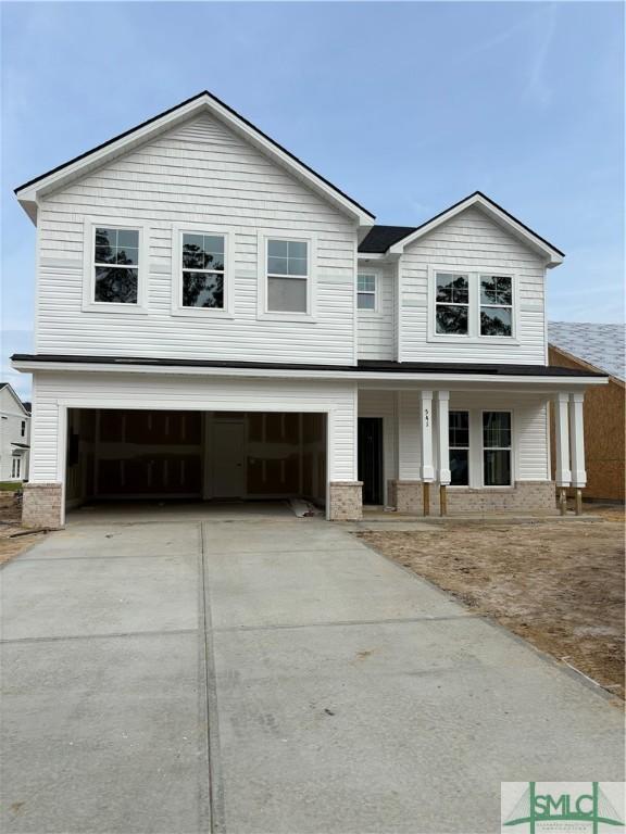 541 Sessile Oak Dr, Savannah, GA 31419 - view of front of house with concrete driveway, an attached garage, brick siding, and a porch