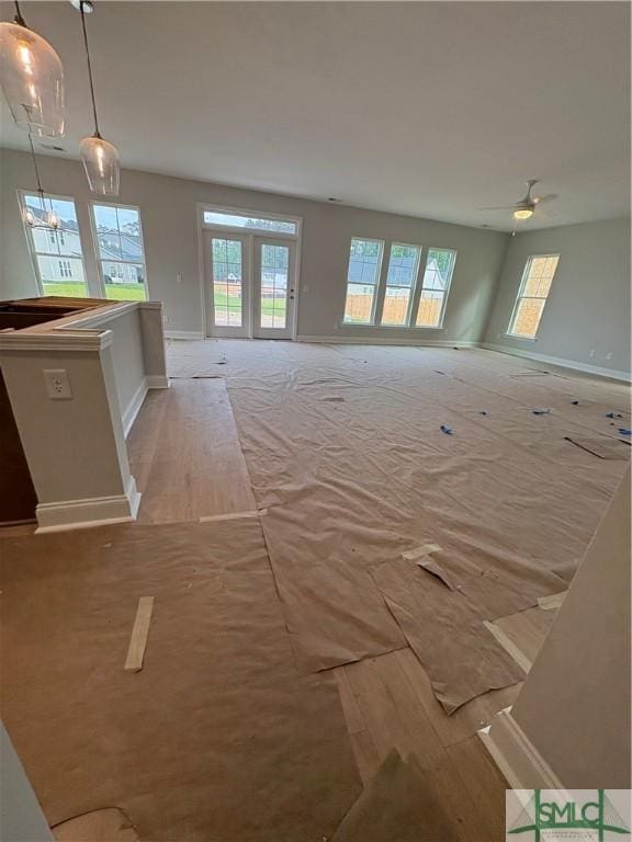 541 Sessile Oak Dr, Savannah, GA 31419 - unfurnished living room featuring baseboards, a chandelier, and light colored carpet