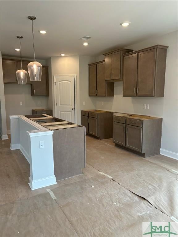 541 Sessile Oak Dr, Savannah, GA 31419 - kitchen with baseboards, a kitchen island, recessed lighting, and decorative light fixtures