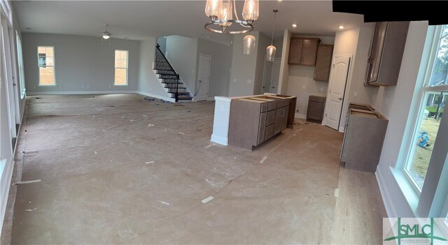 541 Sessile Oak Dr, Savannah, GA 31419 - kitchen featuring ceiling fan, open floor plan, a chandelier, pendant lighting, and a center island