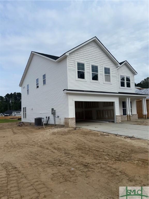 541 Sessile Oak Dr, Savannah, GA 31419 - view of side of property featuring an attached garage, concrete driveway, and covered porch