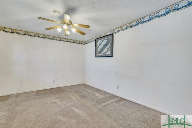 carpeted spare room featuring ceiling fan and a textured ceiling