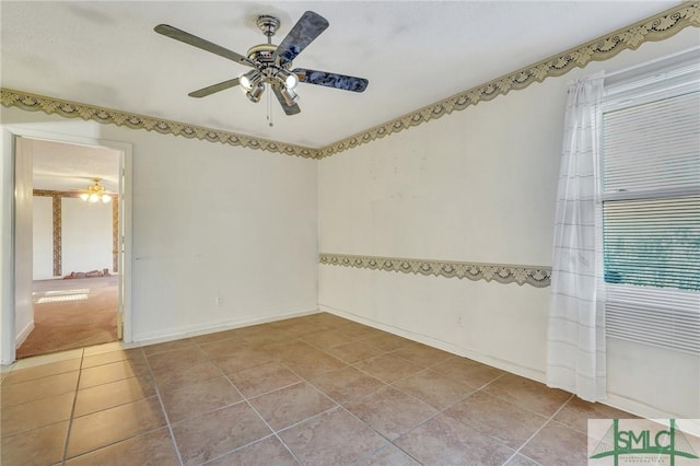 tiled spare room featuring ceiling fan