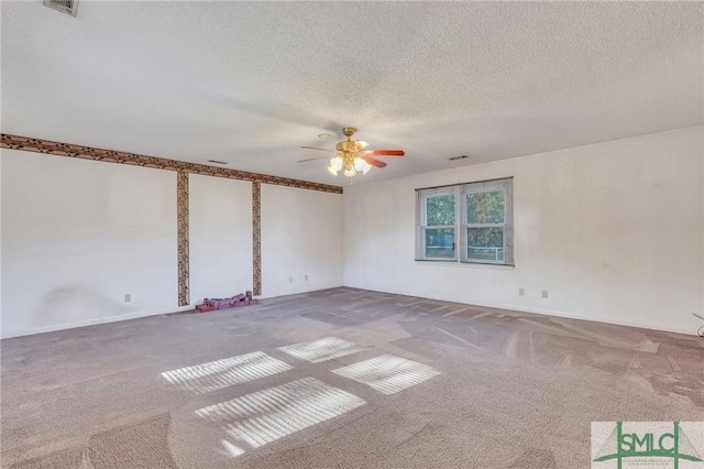 carpeted spare room with a textured ceiling and ceiling fan