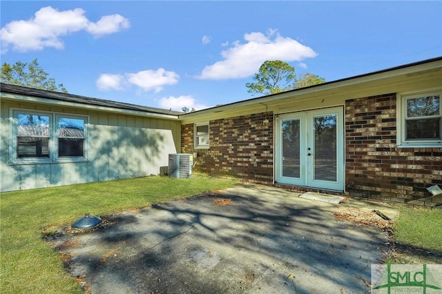 exterior space featuring a lawn, french doors, central AC, and a patio