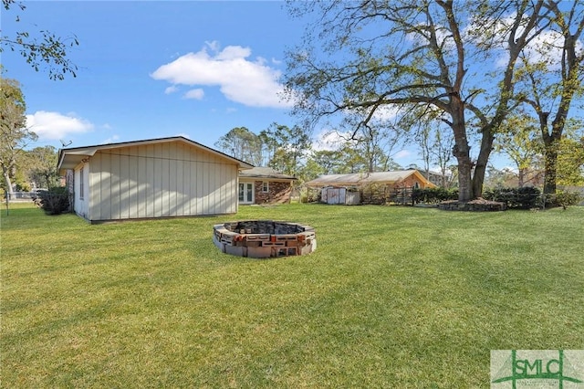 view of yard with a fire pit