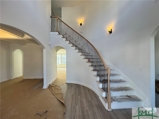 staircase with hardwood / wood-style floors