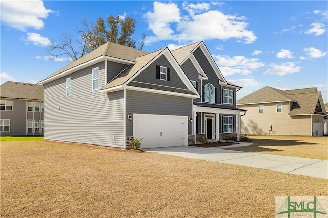 view of front of property featuring a garage, driveway, and a front lawn