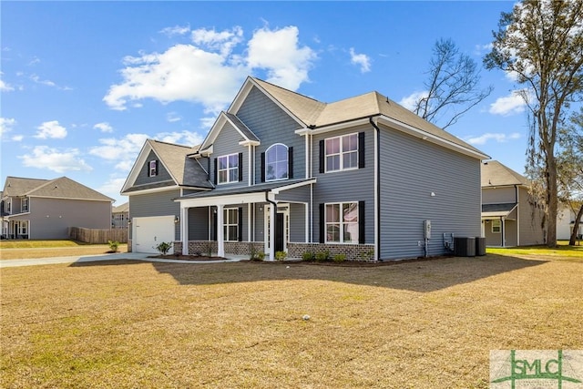 view of front of home featuring brick siding, concrete driveway, a front yard, central AC unit, and a garage