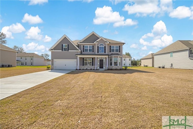 view of front of house with concrete driveway, a garage, and a front yard