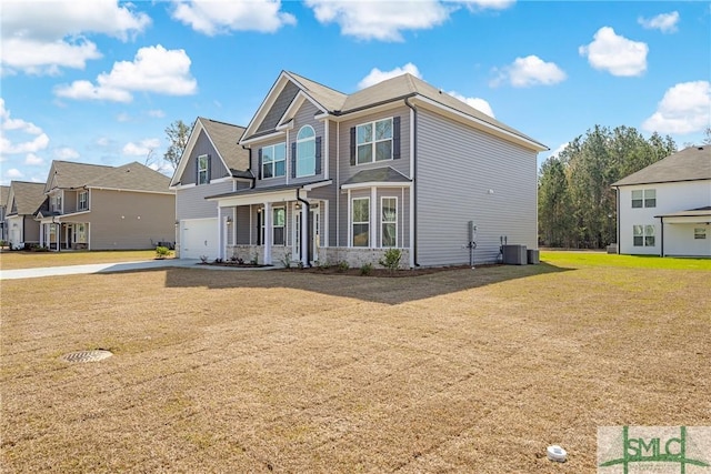 view of front of house with a front lawn, central air condition unit, a residential view, driveway, and an attached garage