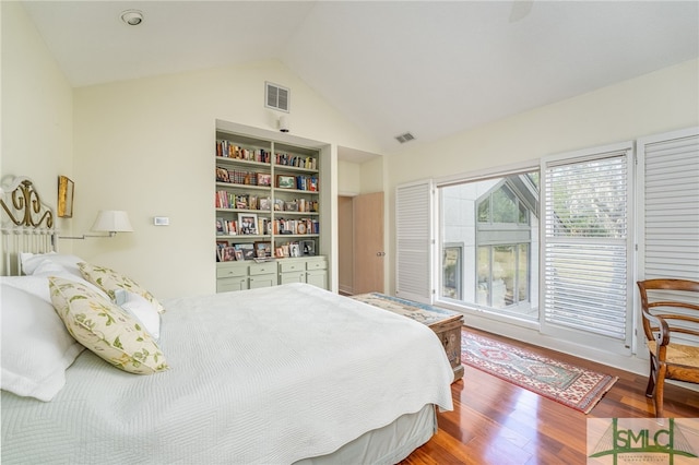 bedroom with vaulted ceiling and hardwood / wood-style floors