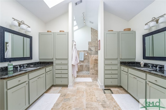 bathroom with vanity, walk in shower, and lofted ceiling with skylight