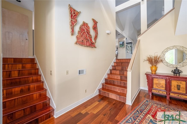 stairs featuring hardwood / wood-style flooring