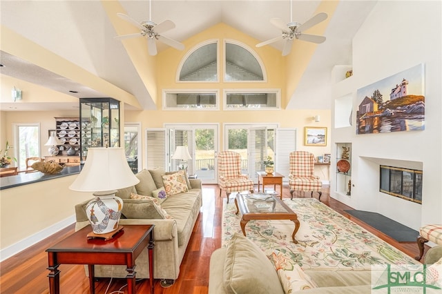 living room featuring high vaulted ceiling, ceiling fan, a healthy amount of sunlight, and dark hardwood / wood-style floors