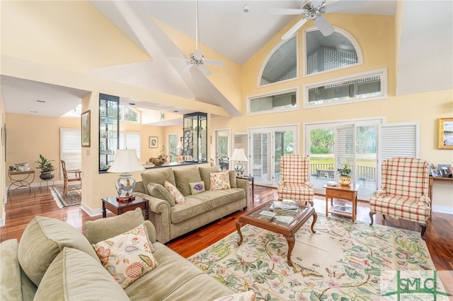 living room featuring hardwood / wood-style flooring, high vaulted ceiling, ceiling fan, and plenty of natural light