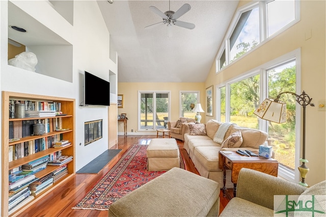 living room featuring high vaulted ceiling, ceiling fan, and dark hardwood / wood-style flooring