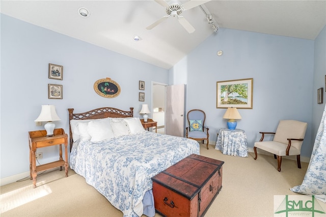 carpeted bedroom featuring rail lighting, ceiling fan, and lofted ceiling with beams