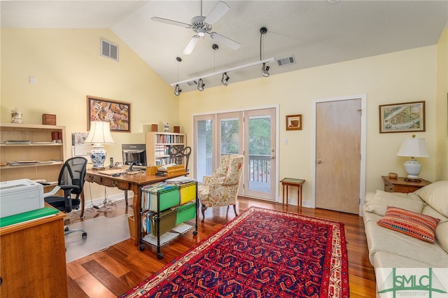 office space featuring vaulted ceiling, track lighting, ceiling fan, and hardwood / wood-style floors