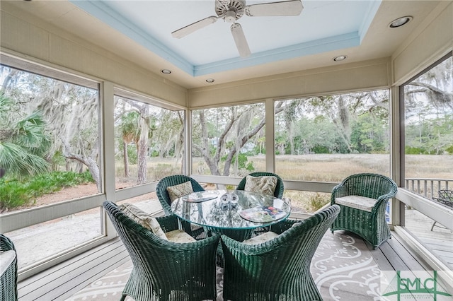 sunroom featuring ceiling fan