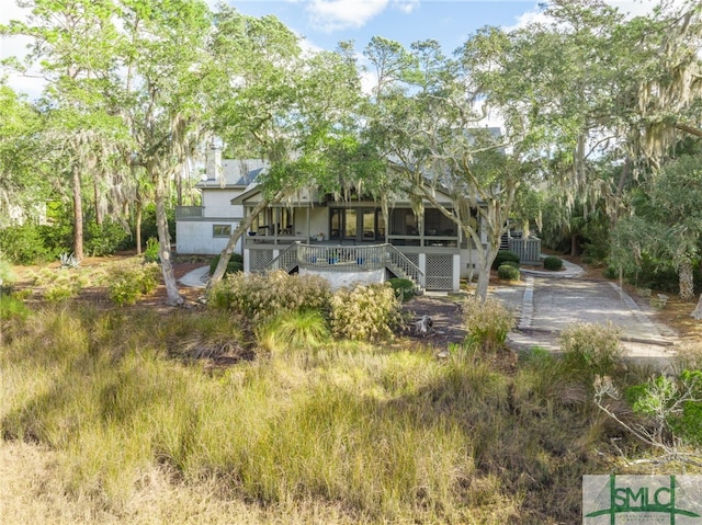 rear view of property featuring a deck