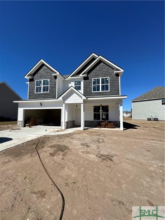 craftsman inspired home featuring driveway and a garage