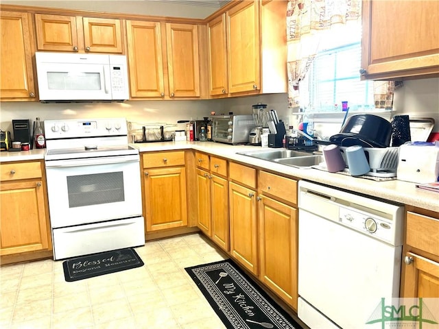 kitchen featuring white appliances and sink