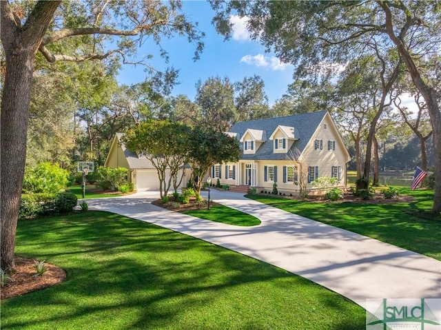 view of front of home with a garage and a front lawn