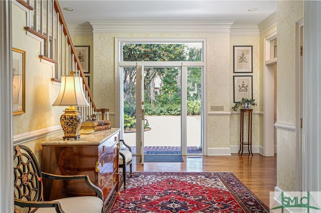 doorway to outside featuring ornamental molding and wood-type flooring