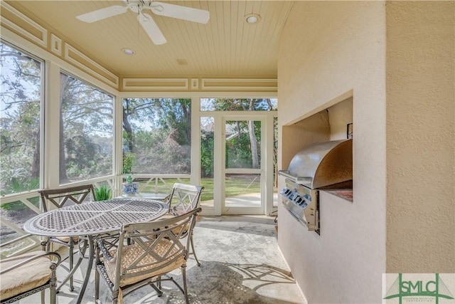 sunroom / solarium with ceiling fan and wood ceiling