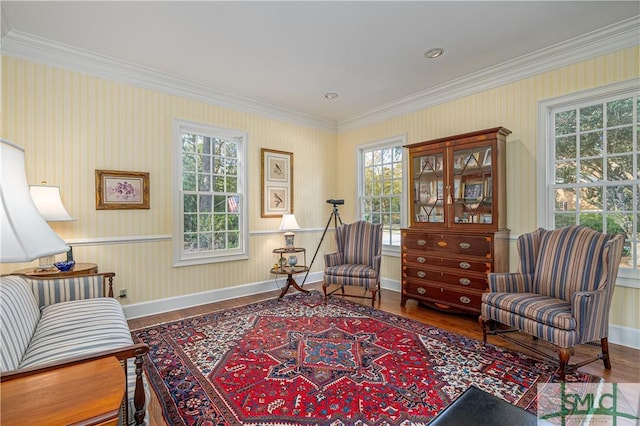 living area featuring a wealth of natural light, hardwood / wood-style flooring, and ornamental molding