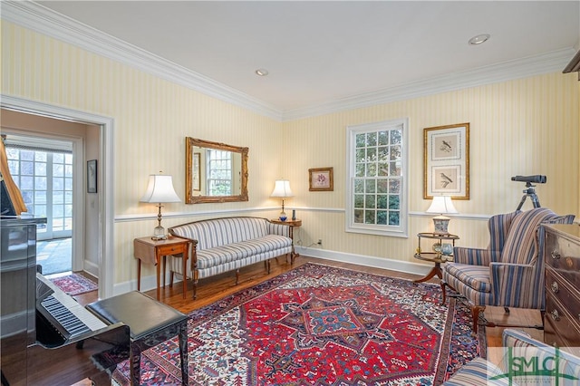 sitting room featuring ornamental molding and wood-type flooring