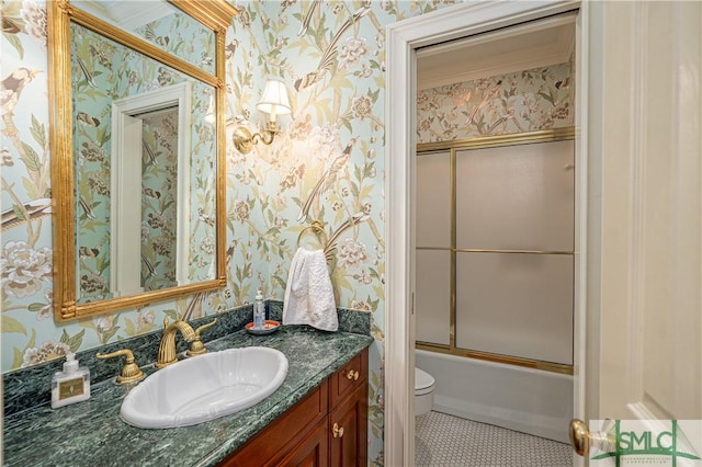 full bathroom with combined bath / shower with glass door, tile patterned floors, vanity, and toilet