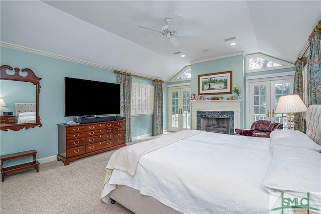 bedroom featuring vaulted ceiling, french doors, ceiling fan, crown molding, and light colored carpet