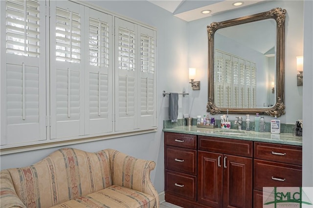 bathroom featuring vaulted ceiling and vanity