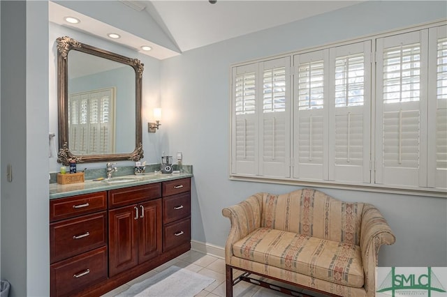 bathroom featuring lofted ceiling, vanity, and tile patterned floors