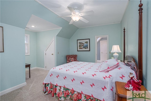 carpeted bedroom with vaulted ceiling, ceiling fan, and crown molding