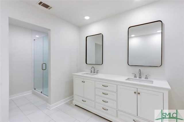 bathroom with vanity, walk in shower, and tile patterned floors