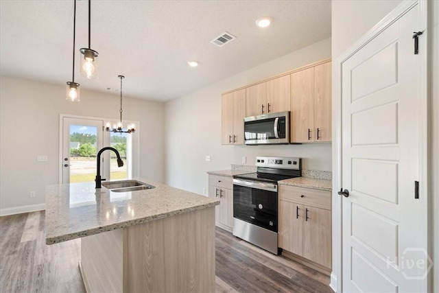 304 Timberlake Dr, Rincon, GA 31312 - kitchen with stainless steel appliances, light brown cabinetry, a sink, wood finished floors, and recessed lighting