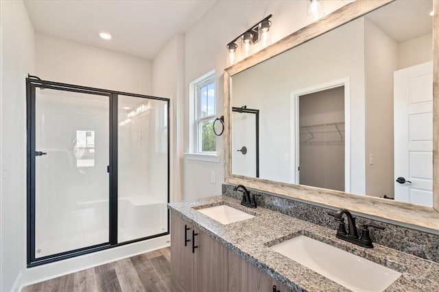 304 Timberlake Dr, Rincon, GA 31312 - bathroom with a shower stall, double vanity, wood finished floors, and a walk in closet