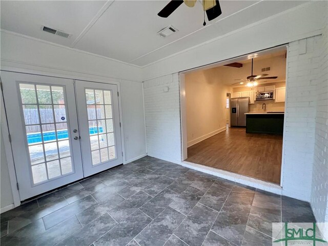 doorway to outside with ceiling fan, french doors, and sink