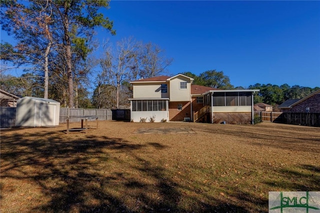 back of property featuring a storage unit, a yard, and a sunroom