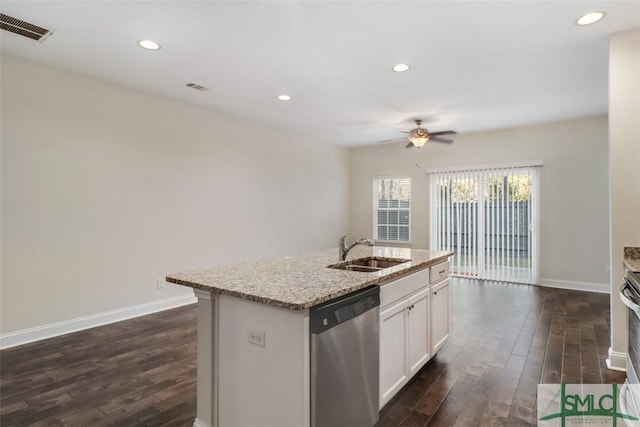 kitchen featuring stainless steel appliances, sink, white cabinetry, ceiling fan, and an island with sink