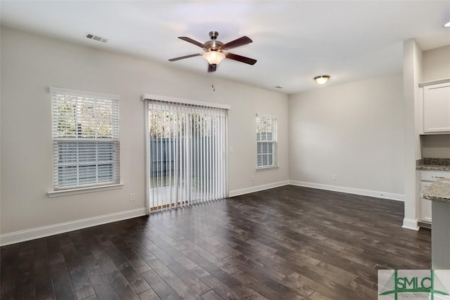 unfurnished living room featuring ceiling fan and dark hardwood / wood-style flooring