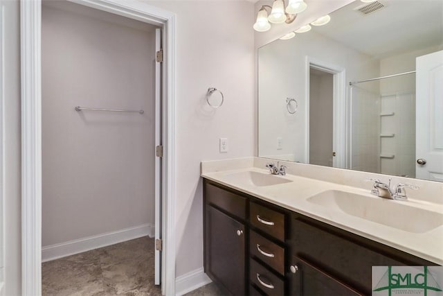 bathroom with an inviting chandelier and vanity