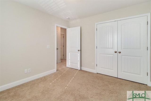 unfurnished bedroom featuring a closet and light carpet